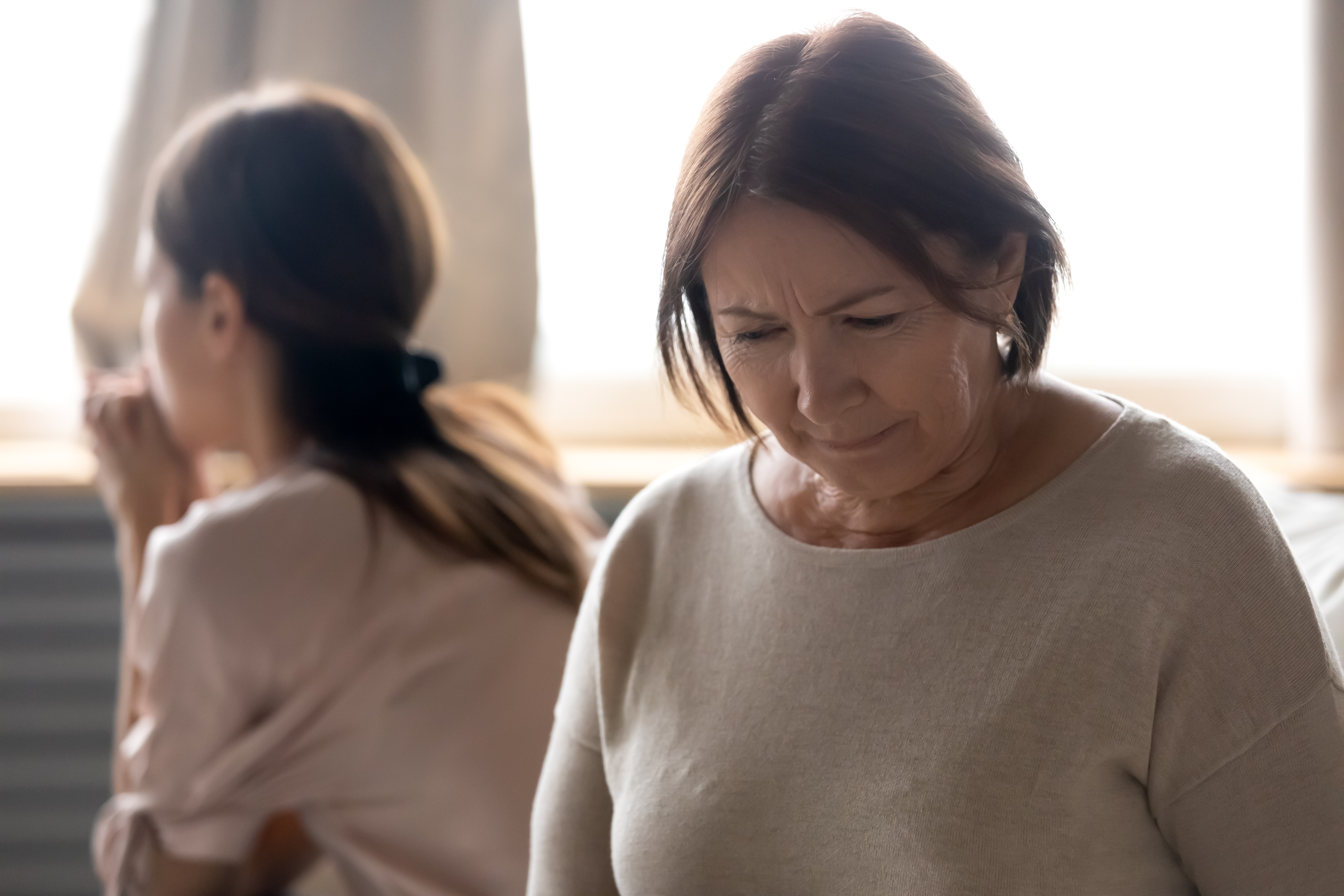 Two women looking away from each other while having a disagreement | Source: Shutterstock