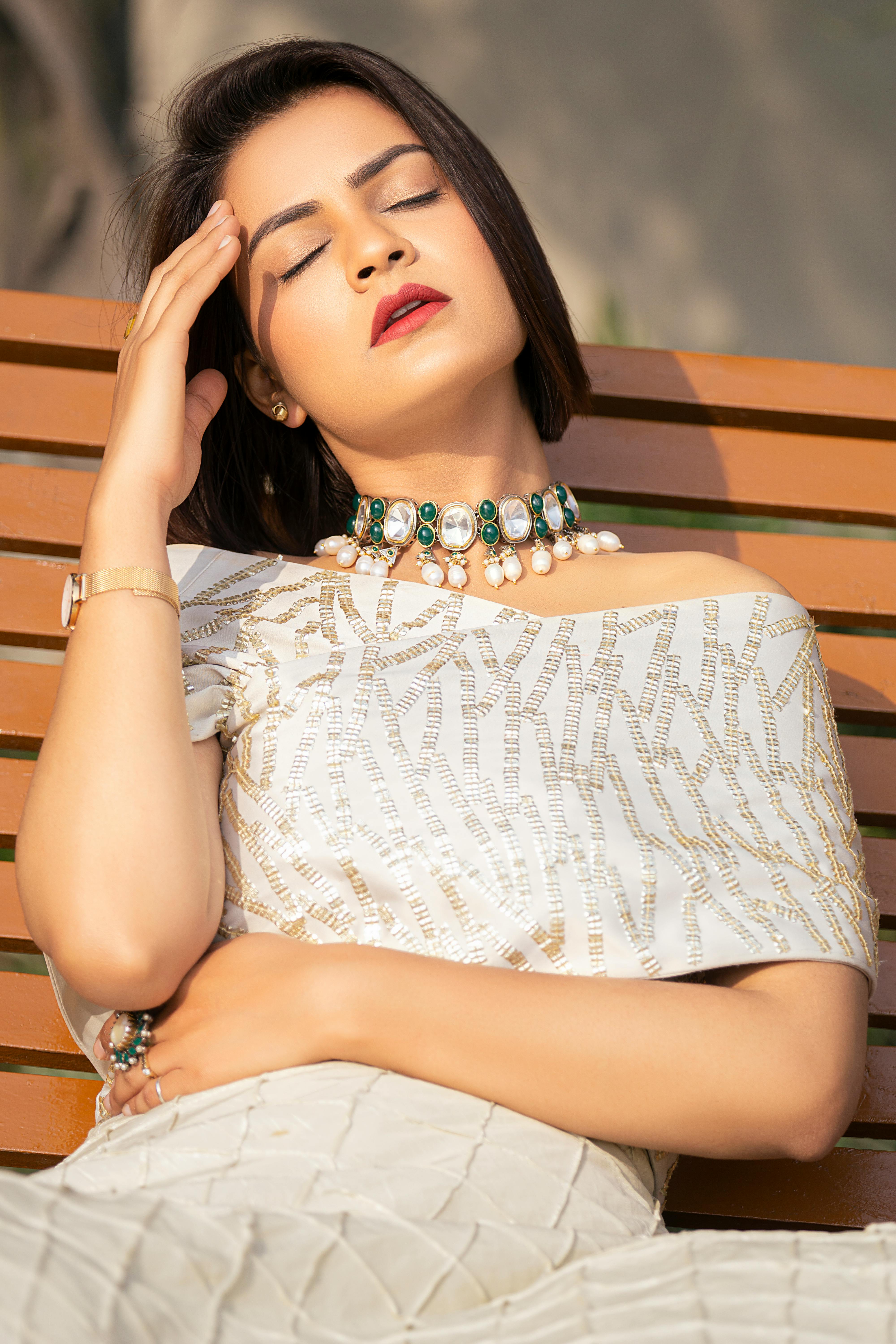 A woman sitting with her hand to her head | Source: Pexels