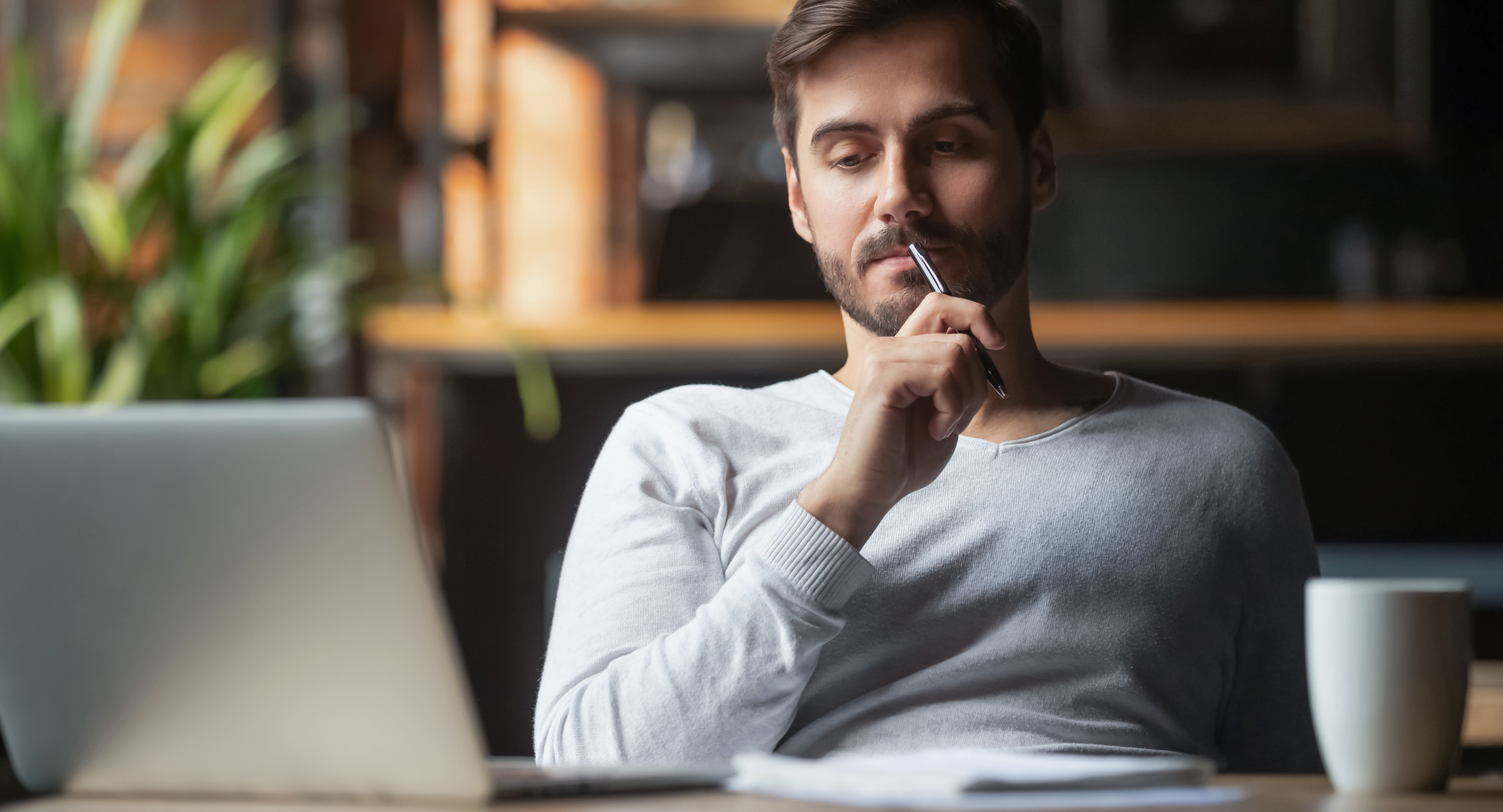 A man sitting alone in his home office | Source: Shutterstock