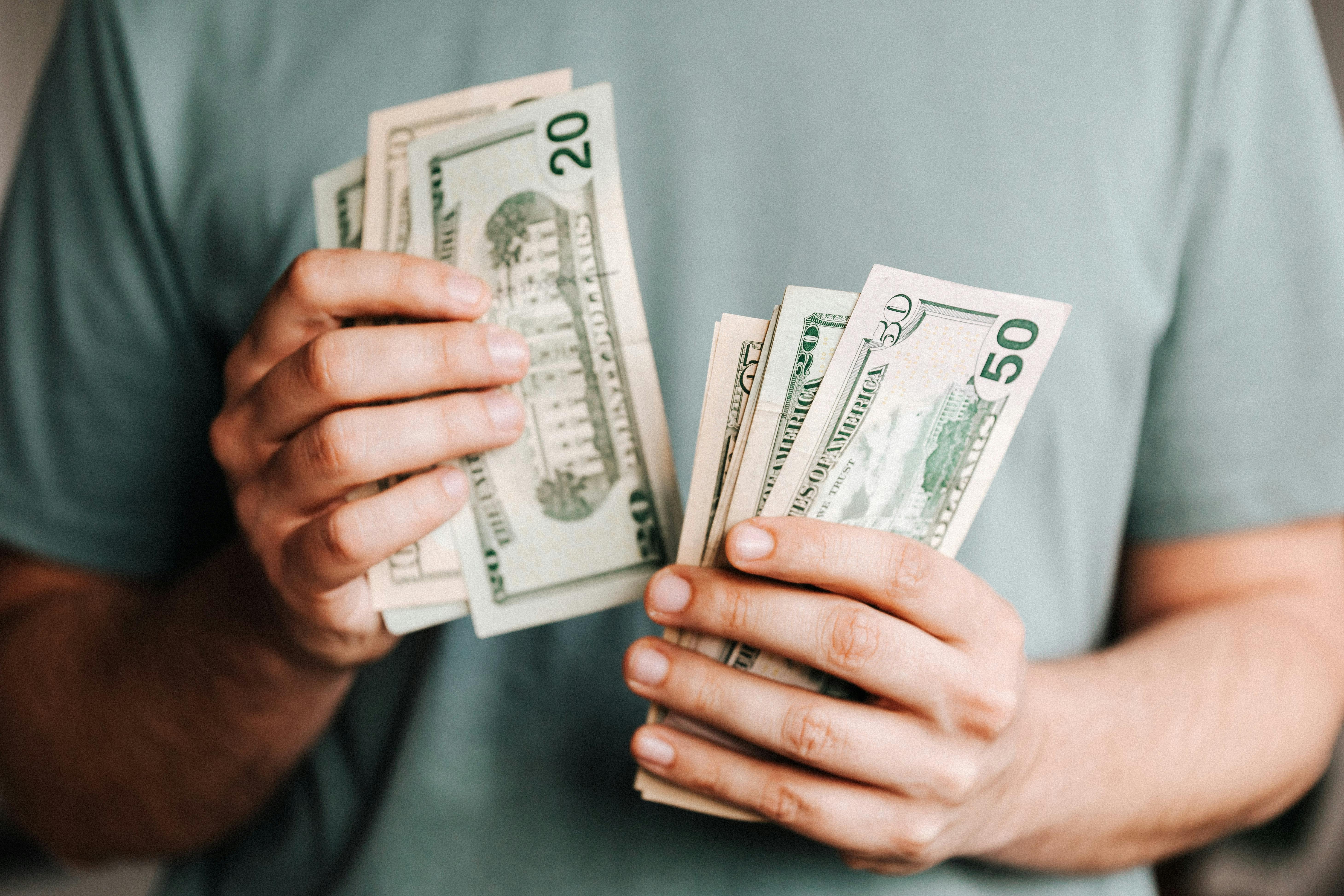 A man holding money | Source: Pexels