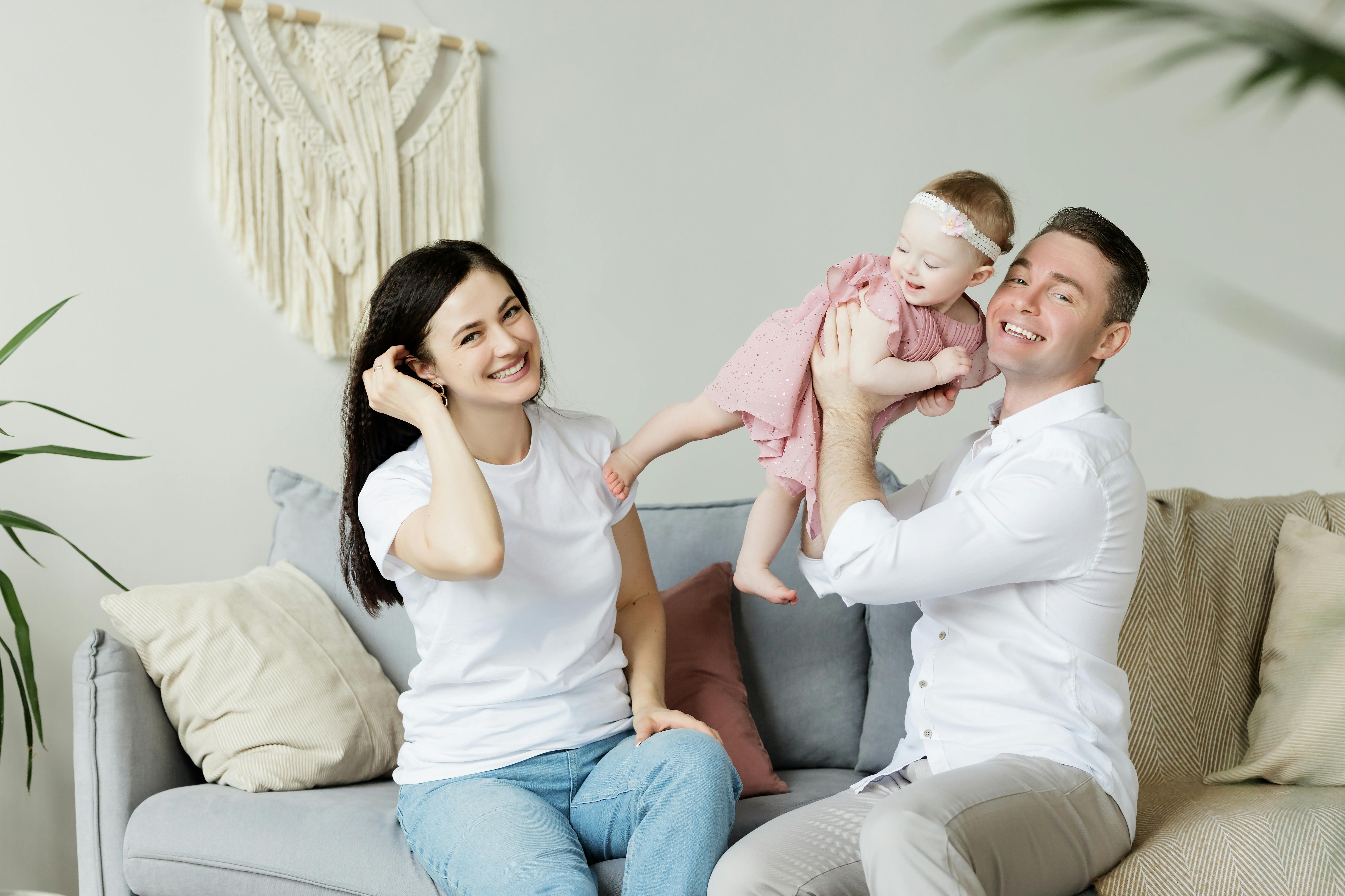 A happy couple with their baby | Source: Pexels