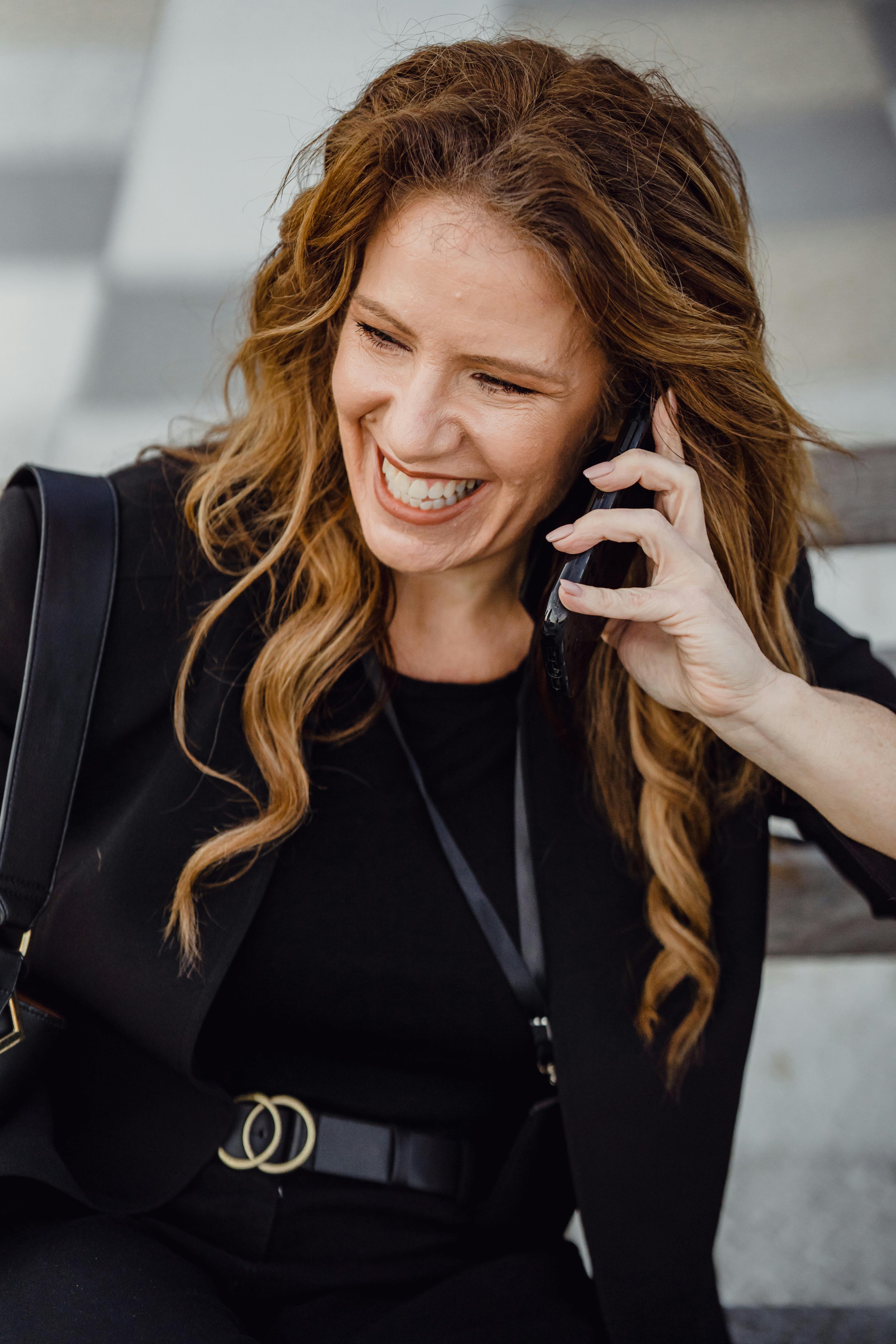 A happy woman talking on the phone | Source: Pexels