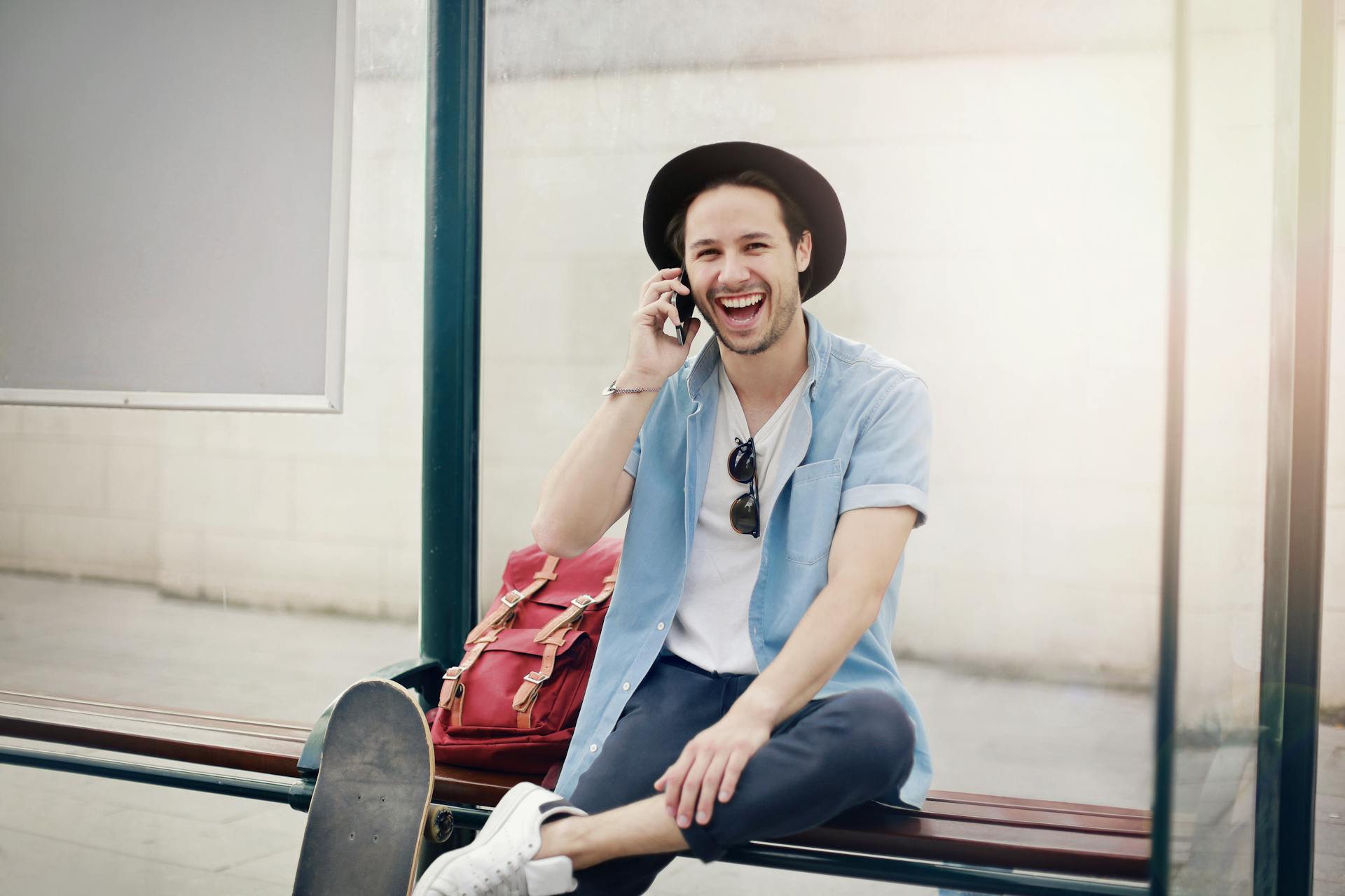 A man laughs while talking on the phone | Source: Pexels